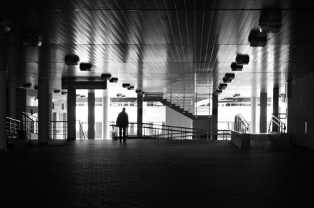 Fragment of modern building. Passage way, columns, ceiling lamps and other details of contemporary construction.の写真素材