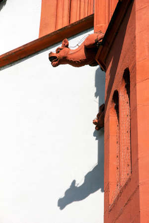 Meieval sculpture of mythic animal on a wall of ancient building in Wurzburg, Germany.の写真素材