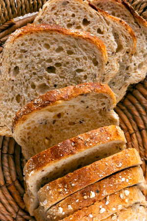 Slices of wheat bread baked with oat flakes and seeds.
