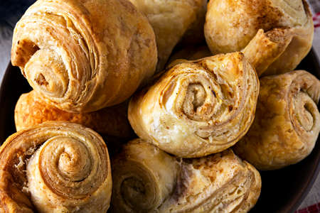 Closeup of fresh homemade puff pastry rolls baked with cinnamon.の写真素材