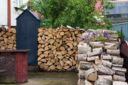 Stack of dry chopped firewood prepared for winter.の写真素材