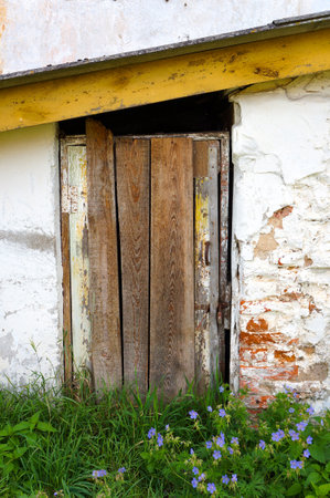 Timeworn Wooden Boarded Door Entrance to Old Brick Building.の写真素材