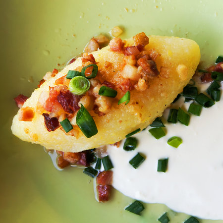 Cepelinai Zeppelin with Sour Cream, Cracklings and and Green Onion. Traditional Lithuanian Food.の写真素材