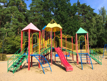 Colorful Modern Children's Outdoor Playground Equipment with Slides and Ladders in Park.の写真素材