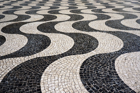 Wavy Pattern of Traditional Mosaic Tiles Pavement in Lisbon, Portugal.