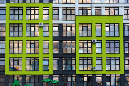 Architecture of Modern Building. Windows on Facade and Reflections of Sky and Clouds in Glass of Windows.の写真素材