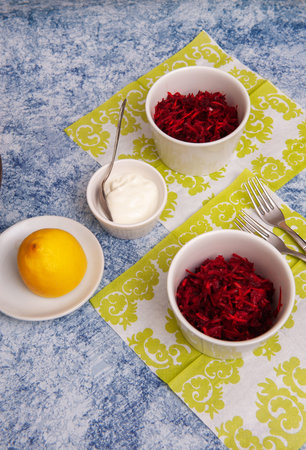 Salad of Fresh Raw Beetroot with Grated Raw Carrot, Apple and Orange on Kitchen Table. Selective Focus.の写真素材