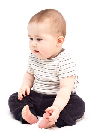 Thoughtful child sits and looks aside  Isolated の写真素材