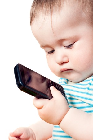 Boy holding a phone and his face reflected in itの写真素材