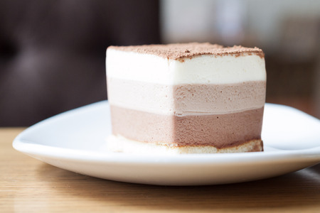 Three chocolate mousse cake slice on a plateの写真素材