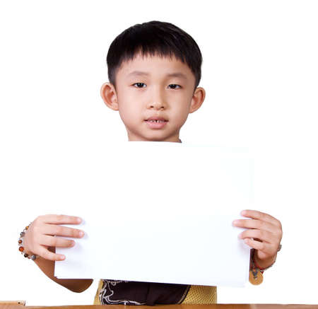 Asian Kid holding and showing a piece of white paper の写真素材