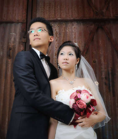 wedding couple infront of an old barn doorの写真素材