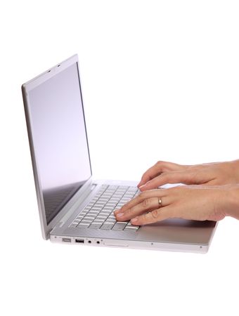 Closeup of a female hand typing on laptop computer on isolated whiteの写真素材