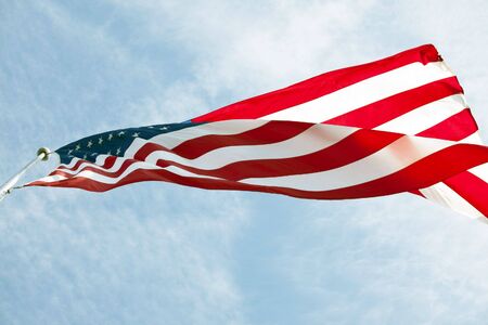Photo of American flag waving in the windの写真素材