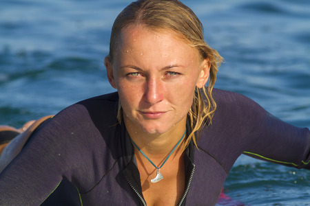 picture of girl surfing a wave in Indonesia.Lombok island.