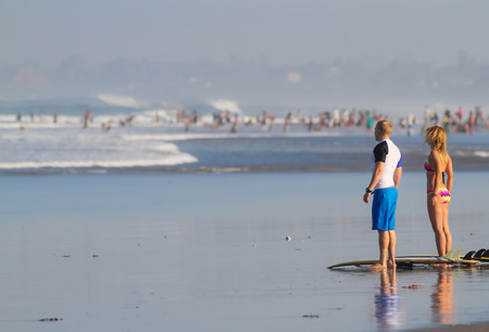 Surfer Woman and Man with Surfboards.