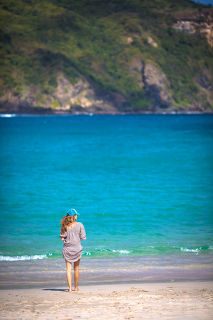 Young woman walking on beachの写真素材
