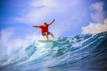 Surfer on Amazing Blue Wave, Bali island.