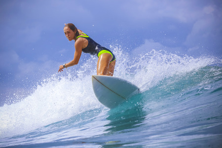 Surfer girl on Amazing Blue Wave, Bali island.の写真素材