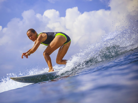Surfer girl on Amazing Blue Wave, Bali island.の写真素材