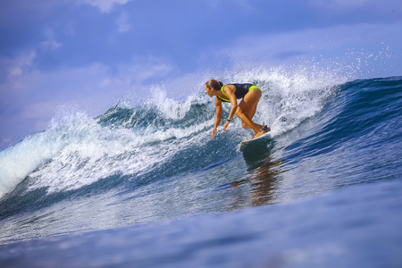 Surfer girl on Amazing Blue Wave, Bali island.の写真素材