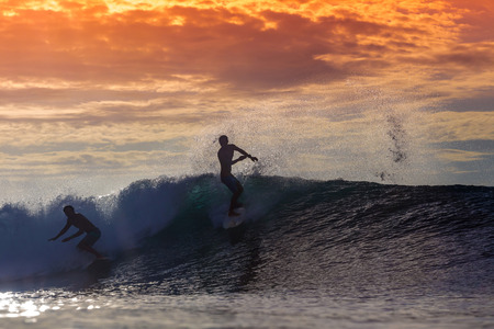 Surfer on Amazing Wave at sunset time, Bali island.の写真素材