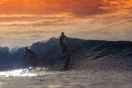 Surfer on Amazing Wave at sunset time, Bali island.の写真素材