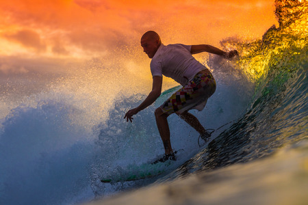 Surfer on Amazing Wave at sunset time, Bali island.