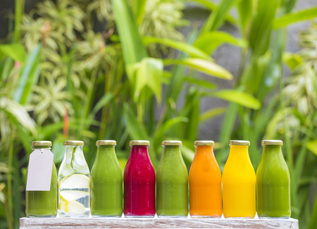 Organic cold-pressed raw vegetable juices in glass bottlesの写真素材