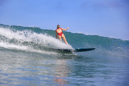 Young woman on blue waveの写真素材