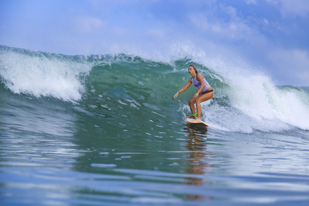 Young woman on blue waveの写真素材