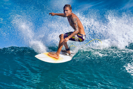 Male surfer on a blue wave at sunny day