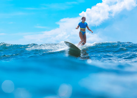 Female Surfer Carving Open Ocean Wave With Confident Stance, Fitness Trainer Energy, Clear Blue Sky,...