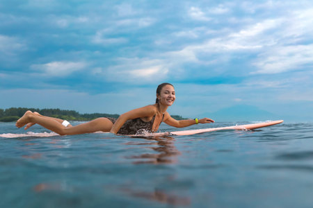 Young Woman Smiling During Sunrise Paddle On Board, Gentle Morning Light And Calm Sea With Focused...