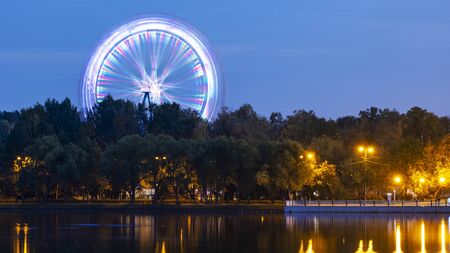 Ferris wheel in the park next to the pondの写真素材