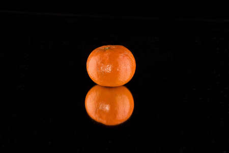 Single Tangerine with reflectionの写真素材