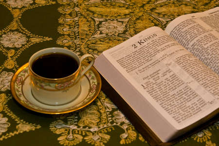 Bible Open on dining room table with coffeeの写真素材