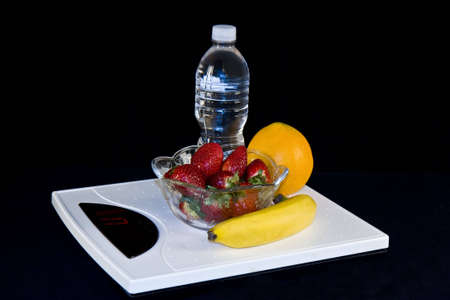 Dieting, scales  fruit and water all go togetherの写真素材