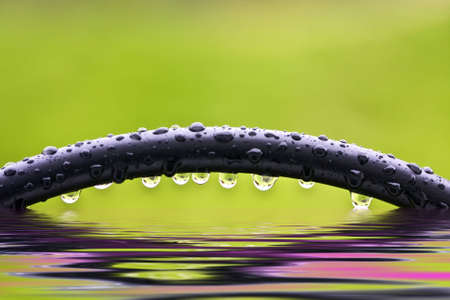 Rod Iron Bar dripping after rain storm and reflections in water (This print without text)floodの写真素材