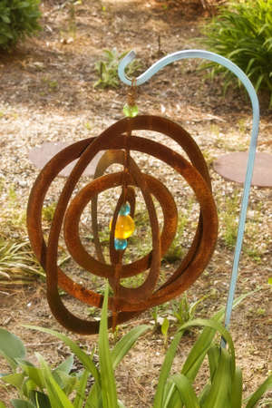 Rusty lawn ornament hanging in gardenの写真素材