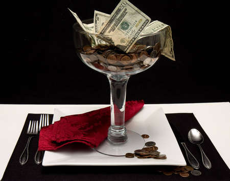 Serving up mony in a large dessert dish at table Concept successの写真素材