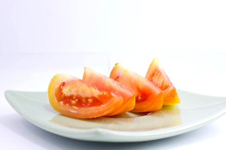 fresh tomato on the plate isolate on the white の写真素材