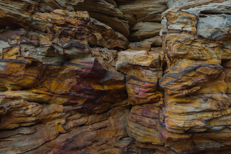 Natural colorful stone background, closeup texture of the old rock.