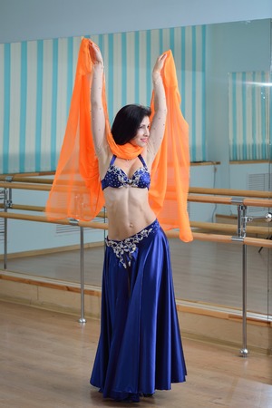 Beautiful woman dancing in arabic dance costume, oriental or belly dance.の写真素材
