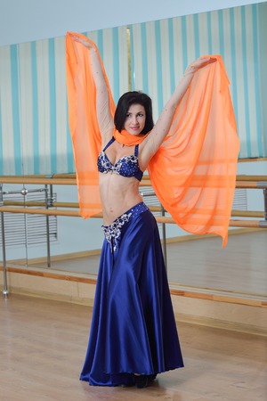 Beautiful woman dancing in arabic dance costume, oriental or belly dance.の写真素材