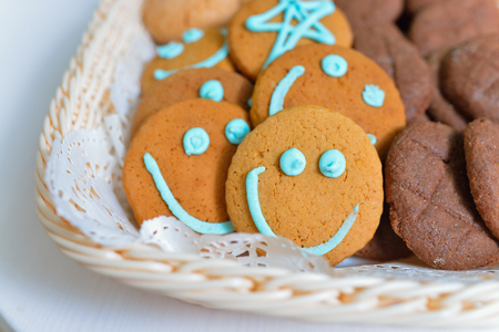 Funny smiling cookies in a food basket.の写真素材
