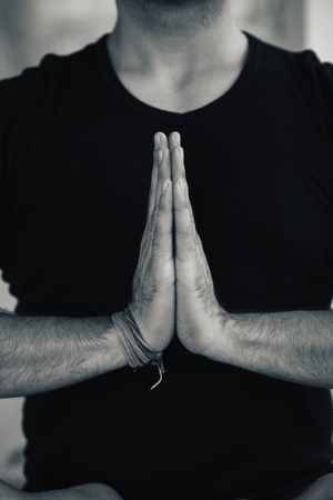 Hands in Namaste prayer mudra by Indian man practicing yogaの写真素材
