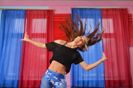 young beauty happy woman dancing having fun with wind in hair