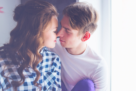 Happy young couple in love close to each other tenderly kissingの写真素材
