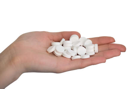 Woman Hand holding pills isolated on white backgroundの写真素材